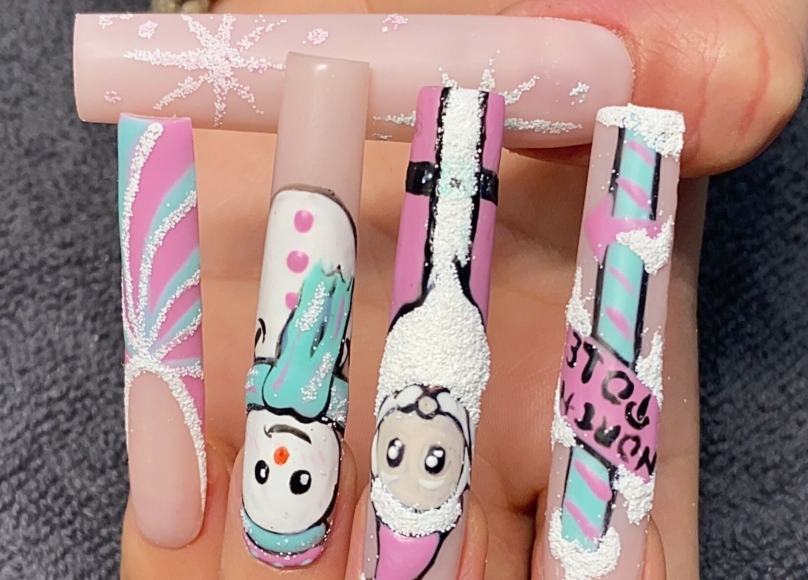 Festive nail art with snowmen and glitter stripes at Glorious Nails and Spa, Ottawa, Ontario, CA.