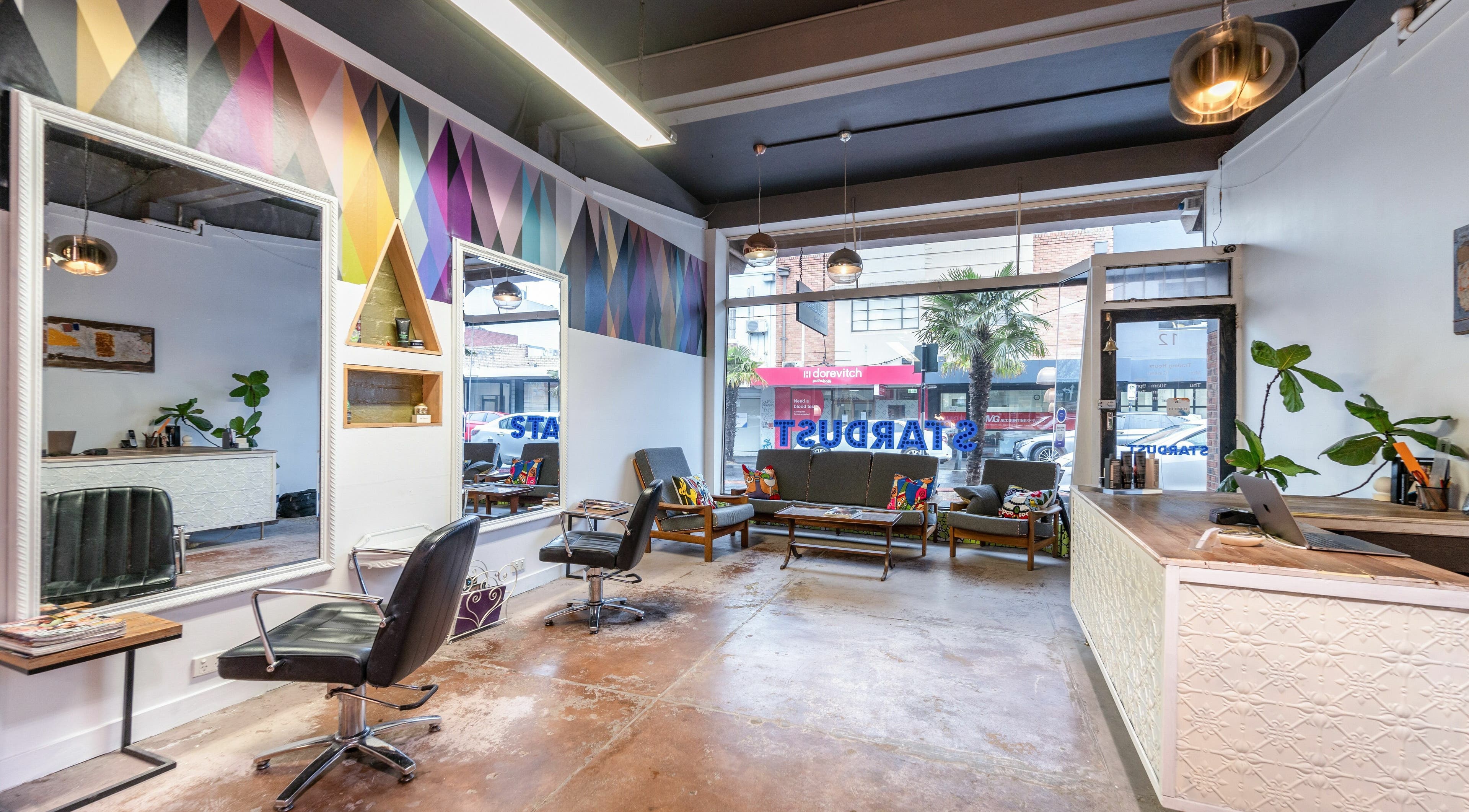 Chic interior of Stardust Hair Studio in Melbourne, Victoria, AU, featuring modern decor and colorful accents.