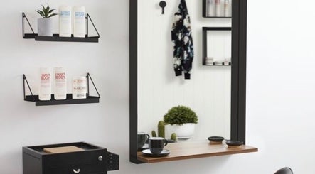 Stylish salon interior at Tilucio, Dublin, County Dublin, IE with shelves and chic decor.