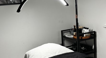 Cozy treatment room at Sunday Rose in Shadoxhurst, England, GB, featuring a comfortable spa bed and ambient lighting.