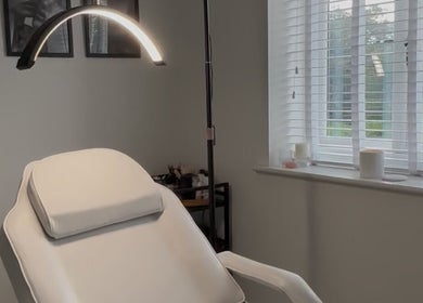 Cozy treatment room at Sunday Rose, Shadoxhurst, England, GB, featuring a comfortable chair and serene lighting.