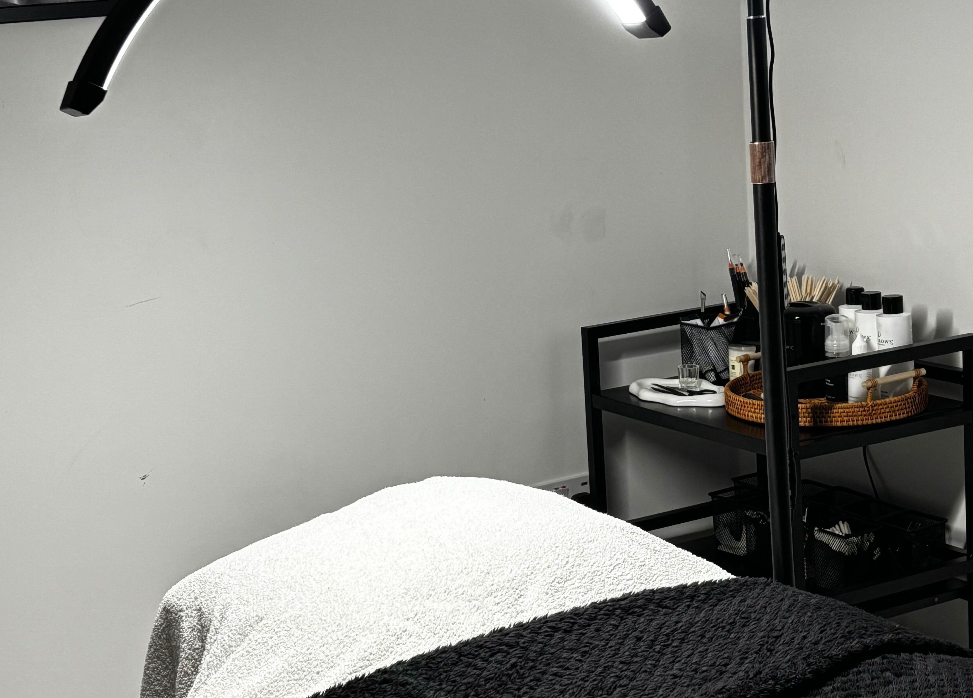 Relaxing spa treatment room at Sunday Rose, Shadoxhurst, England, GB with cozy bed and beauty essentials.