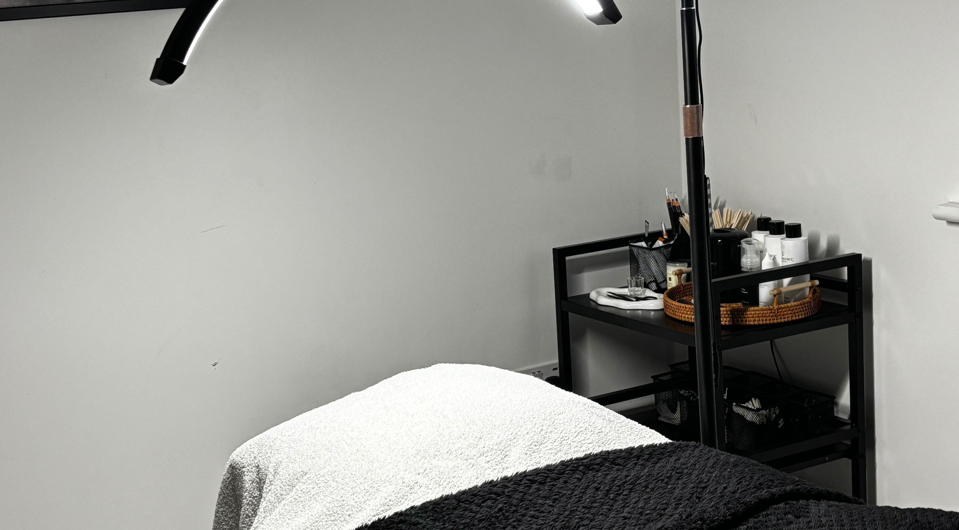 Relaxing spa treatment room at Sunday Rose, Shadoxhurst, England, GB with cozy bed and beauty essentials.