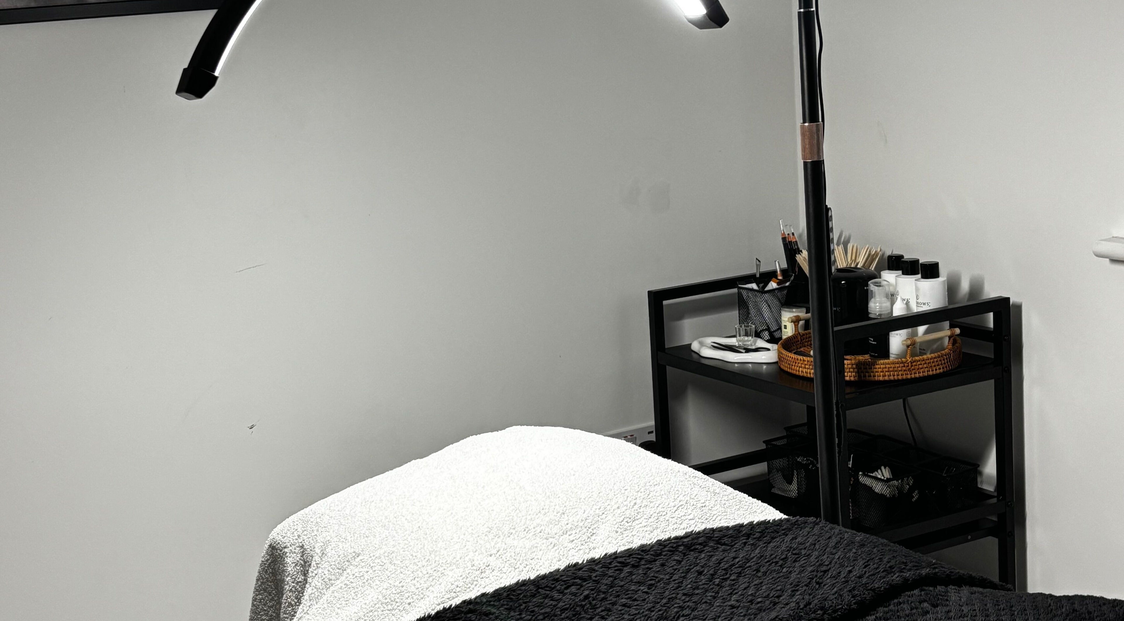 Relaxing spa treatment room at Sunday Rose, Shadoxhurst, England, GB with cozy bed and beauty essentials.