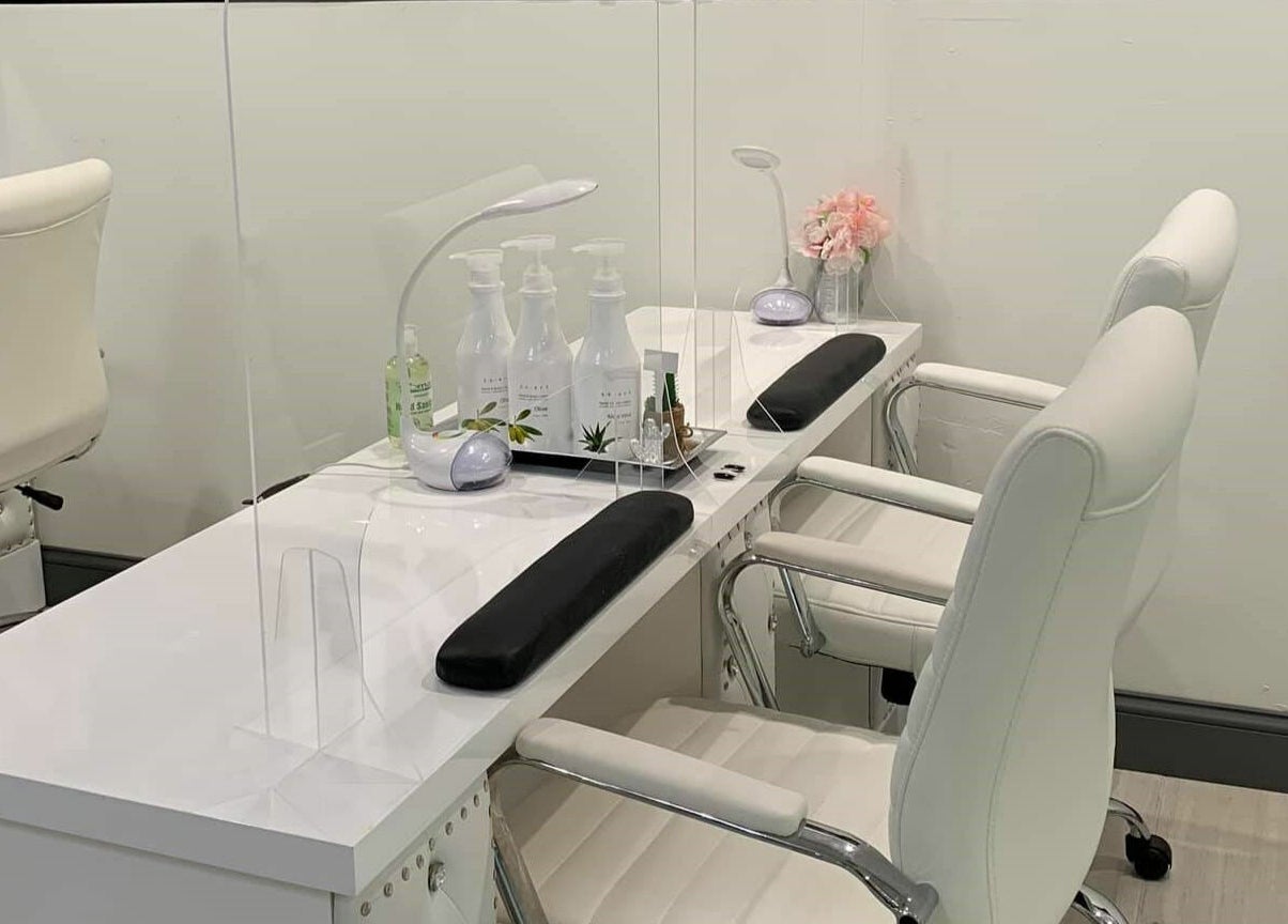 Sleek nail care station at Dashing Diva Nails and Spa, Swampscott, Massachusetts, US, featuring white chairs.