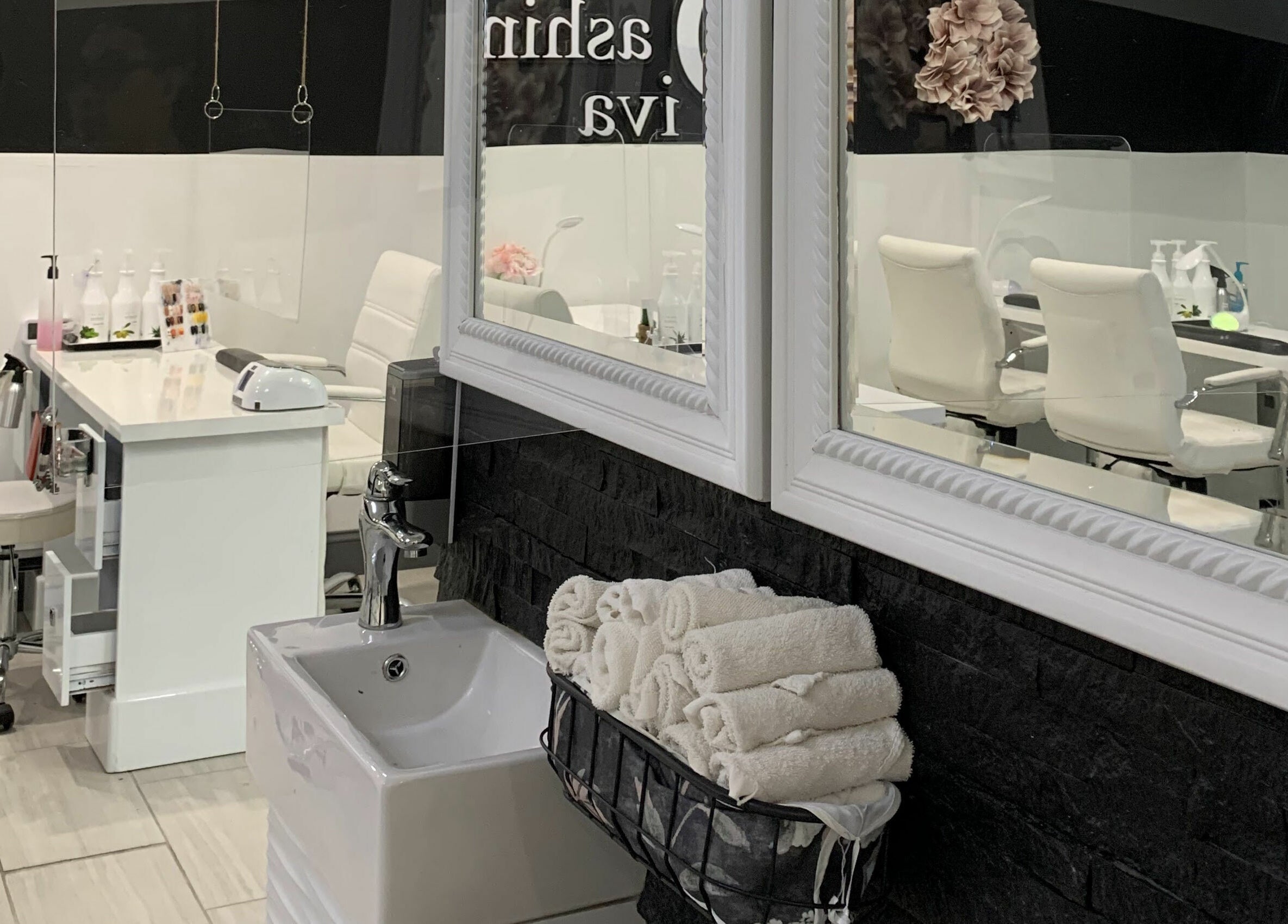 Stylish interior of Dashing Diva Nails and Spa in Swampscott, Massachusetts, US with modern nail stations.