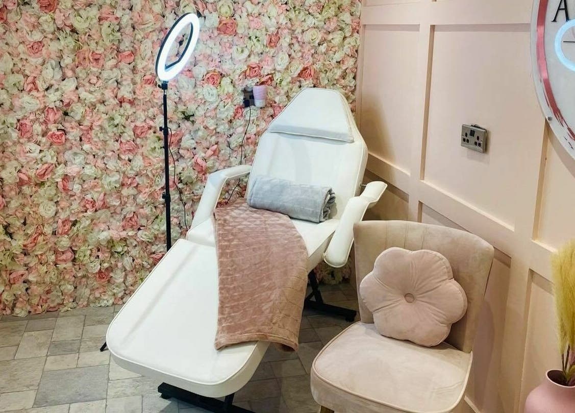 Chic beauty chair at The Beauty Spot, Jarrow, England, GB, enhanced by a vibrant floral wall backdrop.