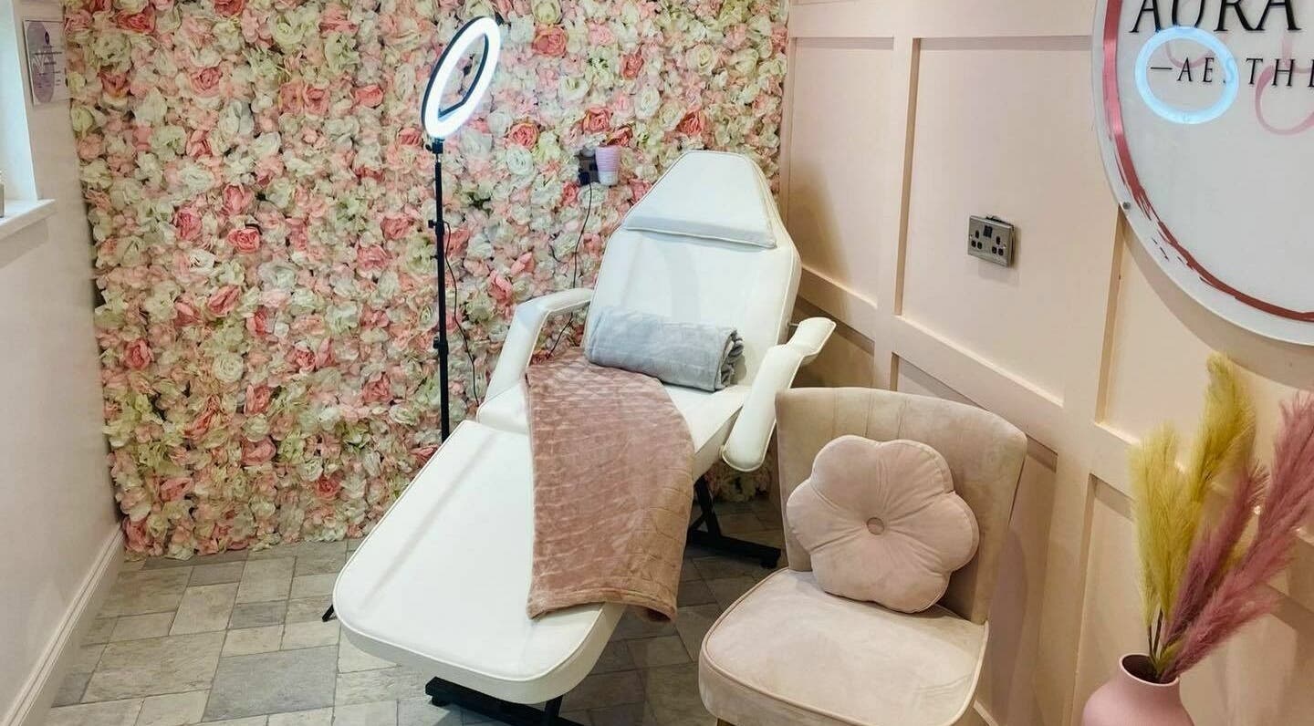 Chic beauty chair at The Beauty Spot, Jarrow, England, GB, enhanced by a vibrant floral wall backdrop.
