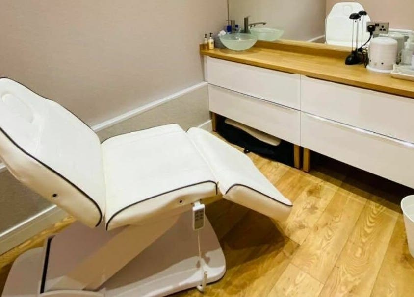 Elegant treatment room at The Beauty Spot in Jarrow, England, GB with cozy chair and wooden floor.