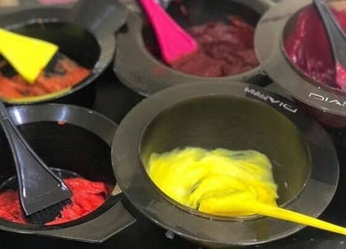 Bright hair dye bowls at Headquarters Salon in Reading, England, GB, showcasing vibrant color options.