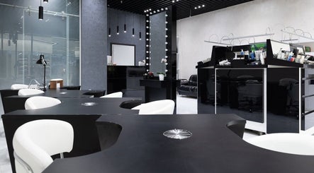Modern interior of Decipher Hair Studio in Cebu City, Central Visayas, PH, showcasing stylish black and white decor.
