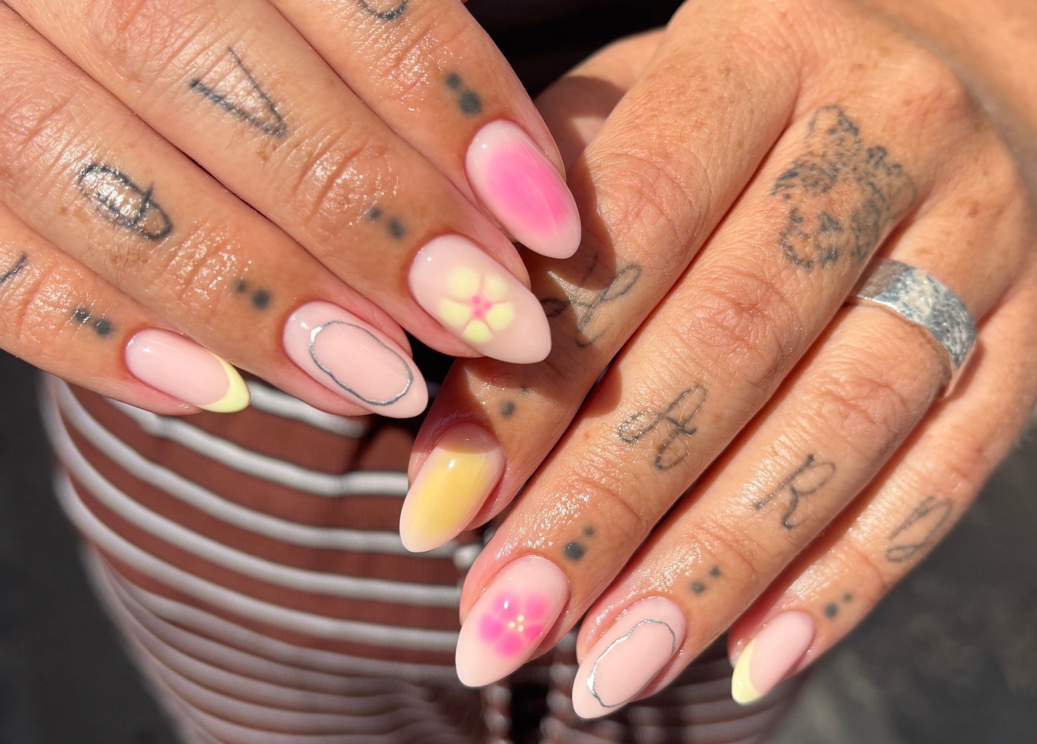 Creative nail art at Mia's Beauty Bar, Earl Shilton, England, GB showcasing unique designs and tattoos.