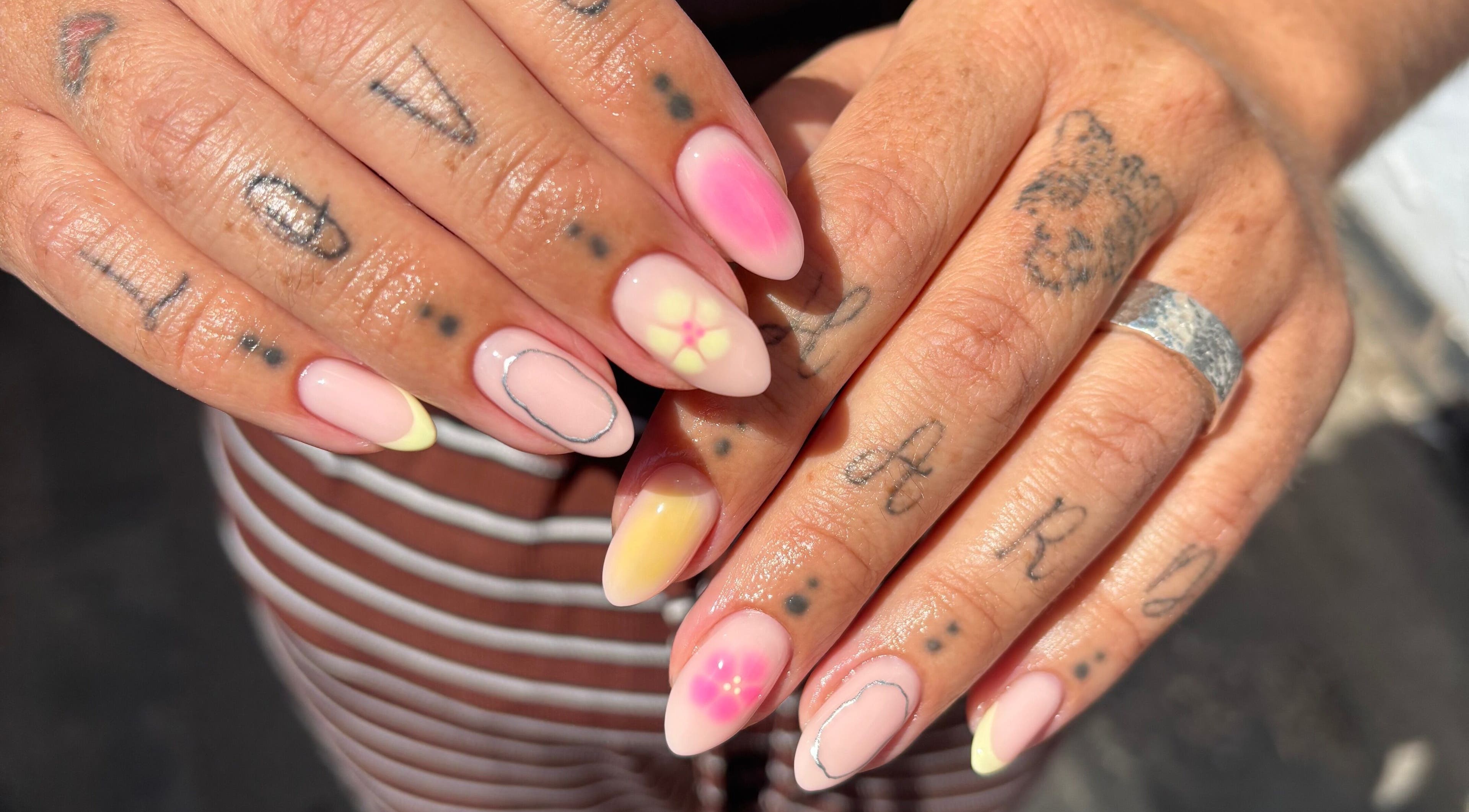 Creative nail art at Mia's Beauty Bar, Earl Shilton, England, GB showcasing unique designs and tattoos.