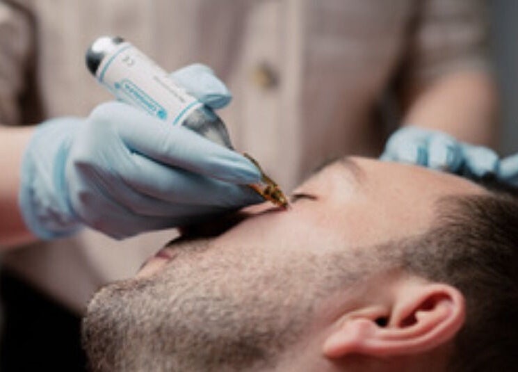 Skilled esthetician performing eye treatment at Esthinity in Glasgow, Scotland, GB.