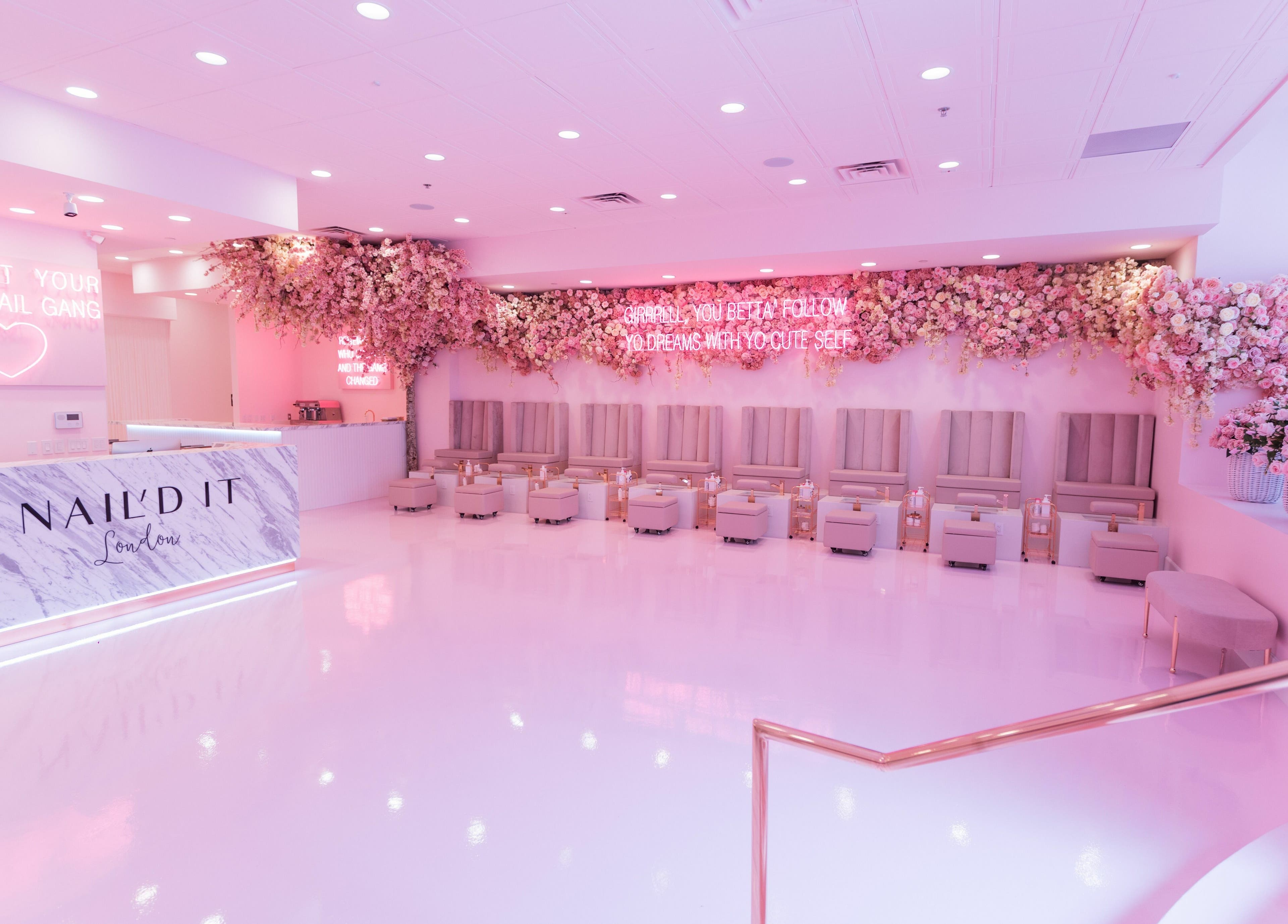 Elegant interior of Nail'd It London, Glendale, California, US, with floral decor and plush seating.