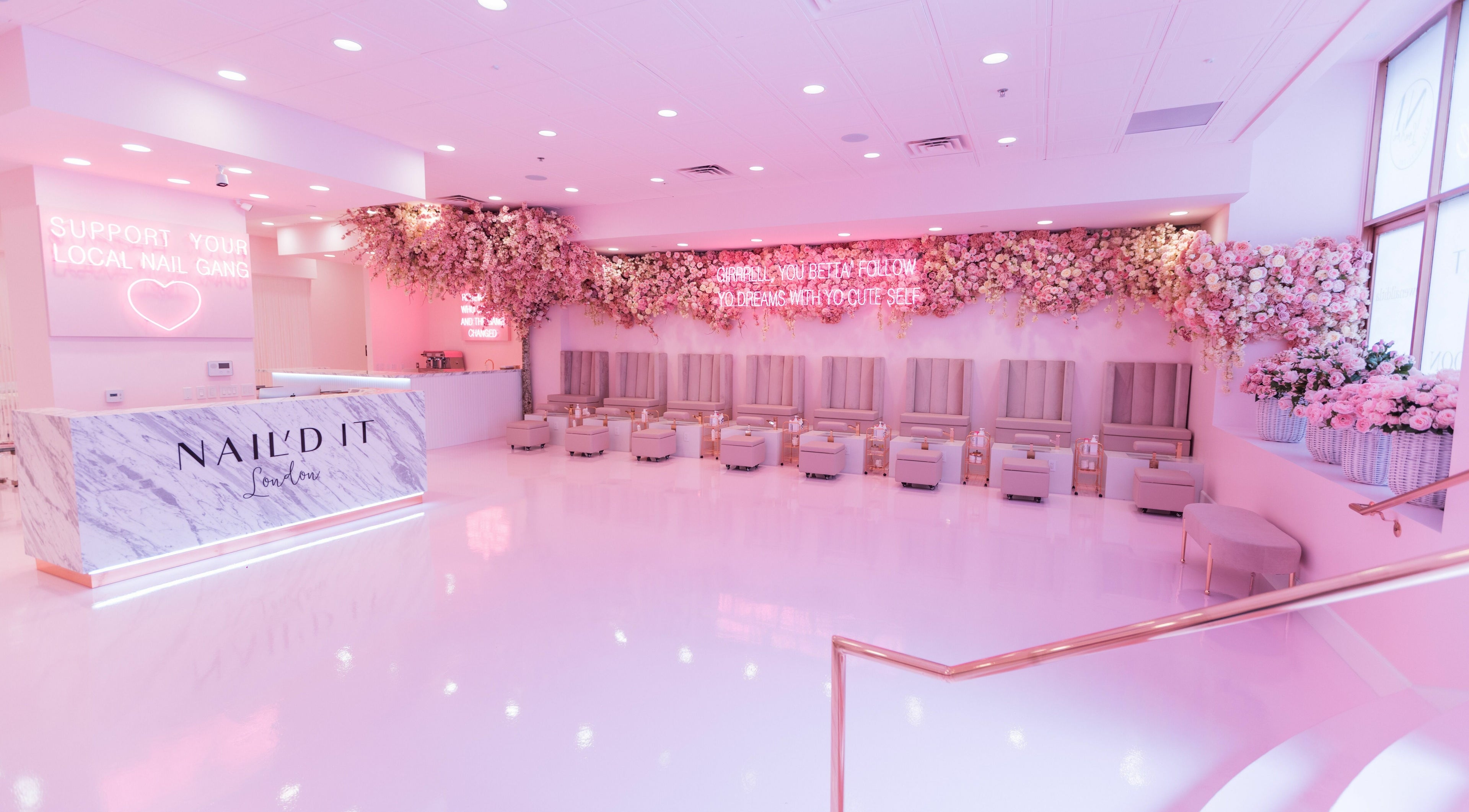 Elegant interior of Nail'd It London, Glendale, California, US, with floral decor and plush seating.