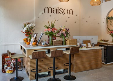 Elegant reception at Maison Nail Spa Silverlake in Los Angeles, California, US with chic decor and fresh flowers.