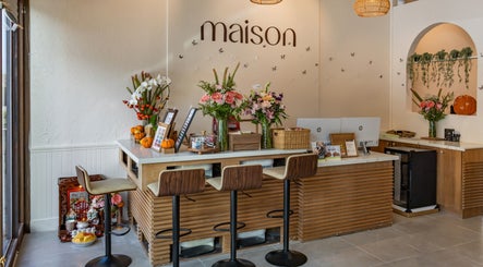 Elegant reception at Maison Nail Spa Silverlake in Los Angeles, California, US with chic decor and fresh flowers.