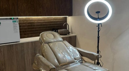 Modern treatment room at Lomas Laser & Beauty (MOSTON), Manchester, England, GB, featuring a sleek chair and lighting.