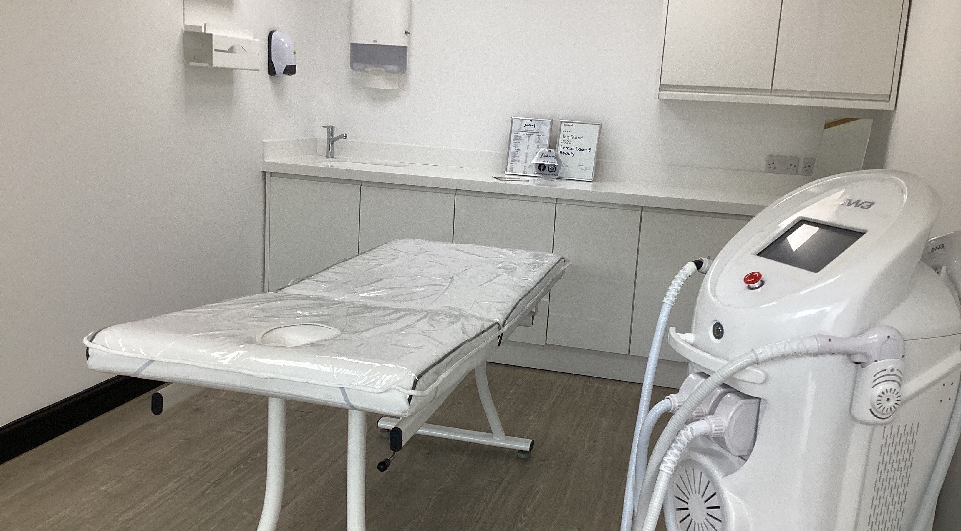 Modern treatment room at Lomas Bare Beauty (CITY CENTRE), Manchester, England, GB with advanced equipment.