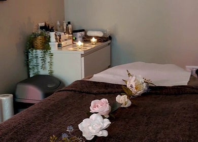 Relaxing treatment room at Hayley Hicks - Beauty Specialist, Malmesbury, England, GB with candles and flowers.