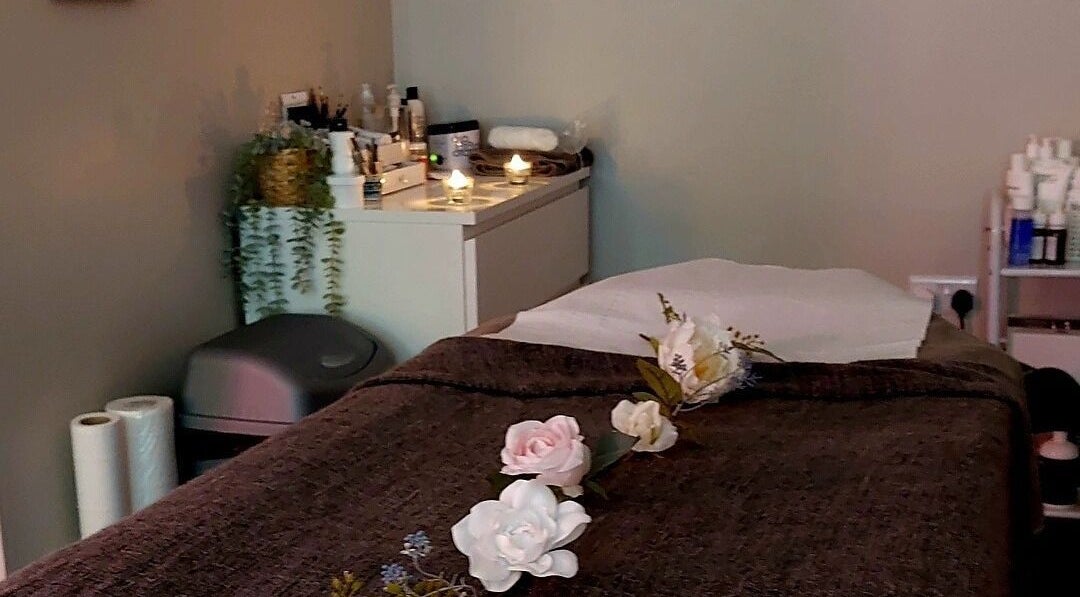 Relaxing treatment room at Hayley Hicks - Beauty Specialist, Malmesbury, England, GB with candles and flowers.