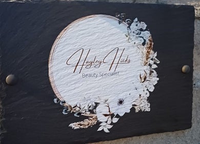 Hayley Hicks - Beauty Specialist sign on a stone wall, Malmesbury, England, GB.