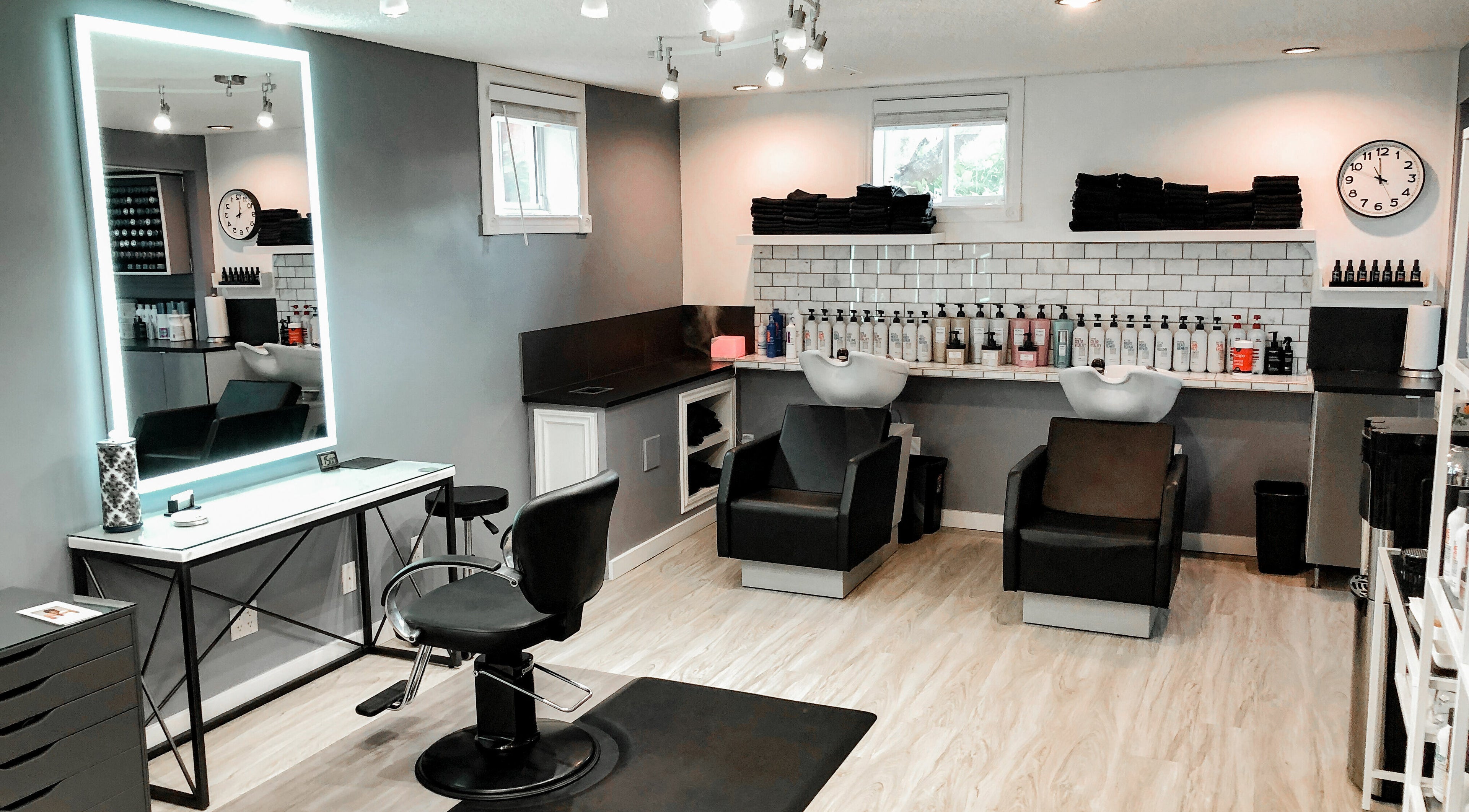 Elegant hair salon interior at Cast + Court, Slave Lake, Alberta, CA, featuring modern chairs and sleek design.