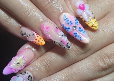 Colorful and intricate nail art at Nailsquad in Deal, England, GB, showcasing unique floral and geometric designs.