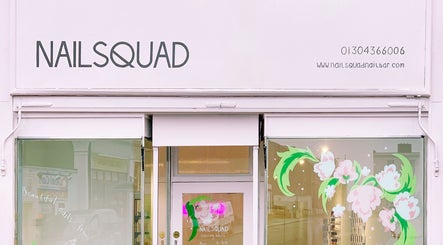 Nailsquad salon facade in Deal, England, GB featuring elegant signage and floral window designs.