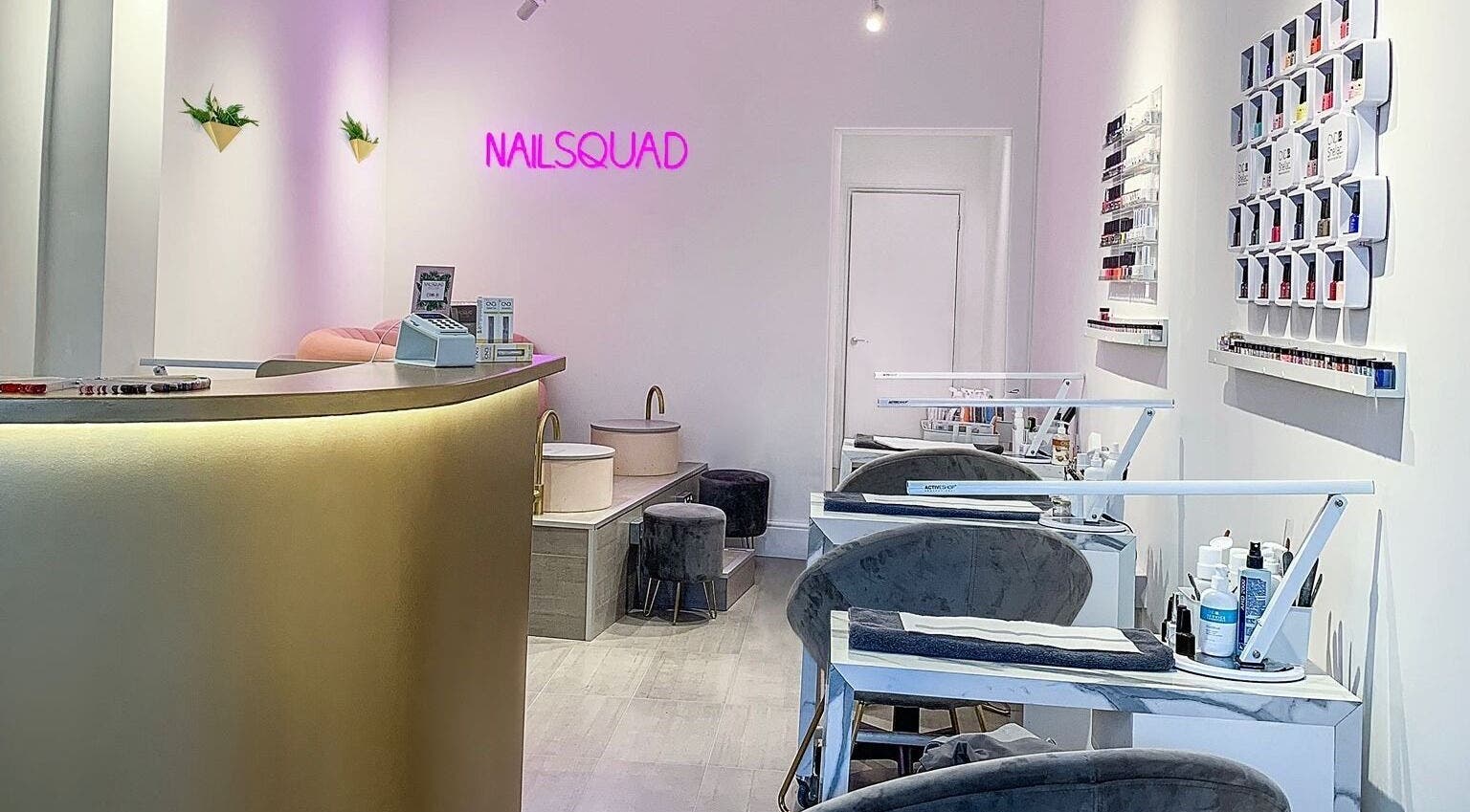 Interior of Nailsquad in Deal, England, GB showcasing stylish nail stations and decor.