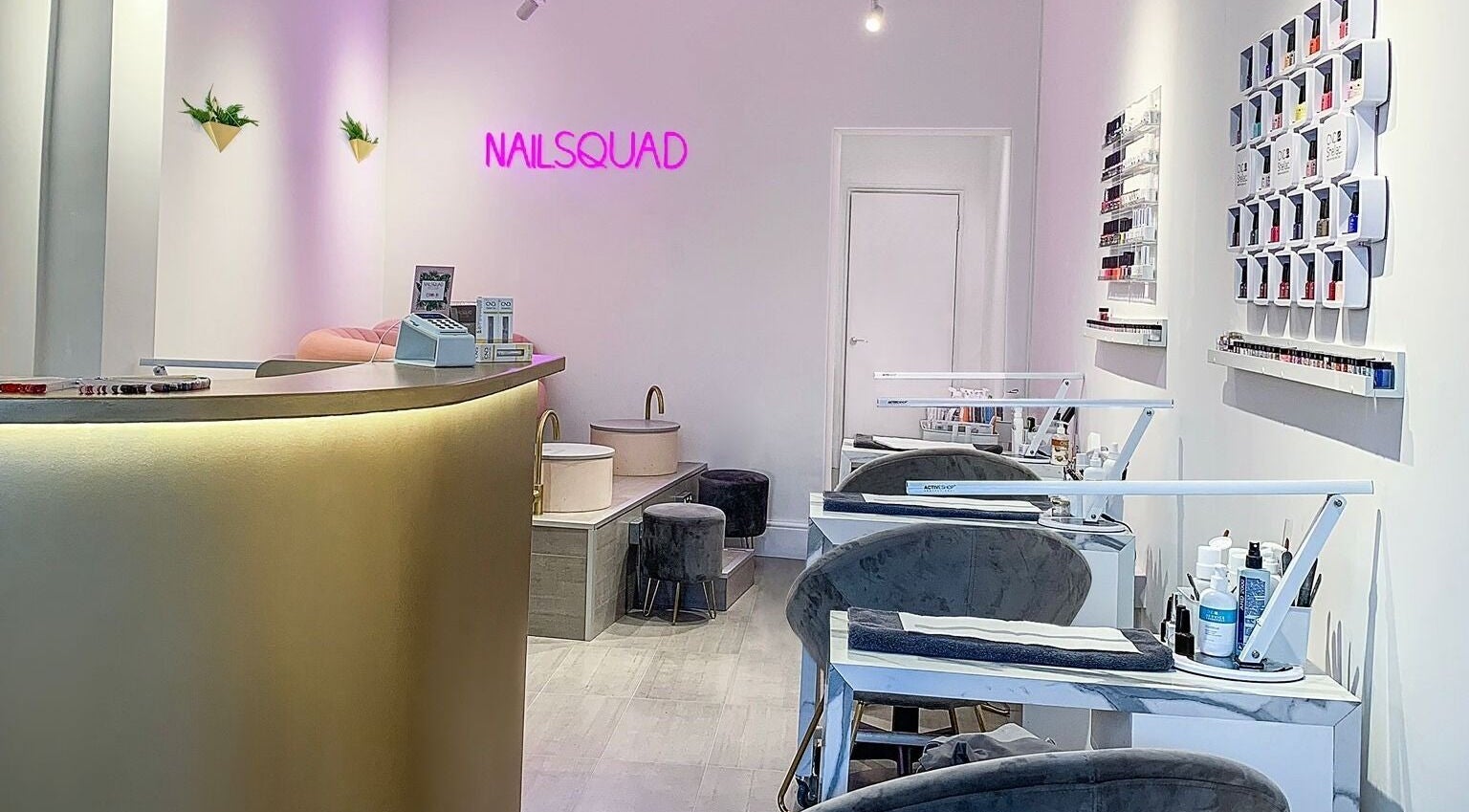 Interior of Nailsquad in Deal, England, GB showcasing stylish nail stations and decor.