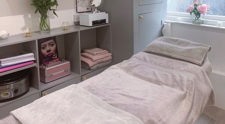Cosy treatment room at Nailsquad in Deal, England, GB, featuring soft pink towels and elegant decor.