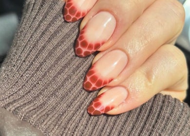 Stunning honeycomb nail art by Nailsquad in Deal, England, GB, showcasing intricate red gradient design.