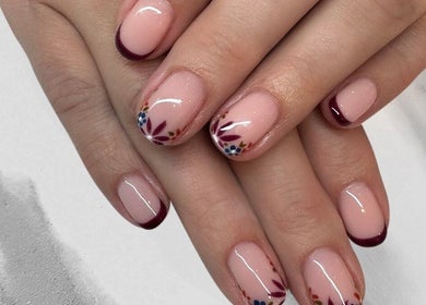 Elegant nail art with floral designs at Nailsquad in Deal, England, GB.