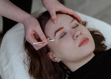 Woman receiving eyebrow treatment at Embody Wellness Studio and Clinic, Steinbach, Manitoba, CA.
