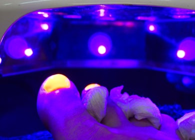 Foot under UV light during a pedicure at Embody Wellness Studio and Clinic, Steinbach, Manitoba, CA.