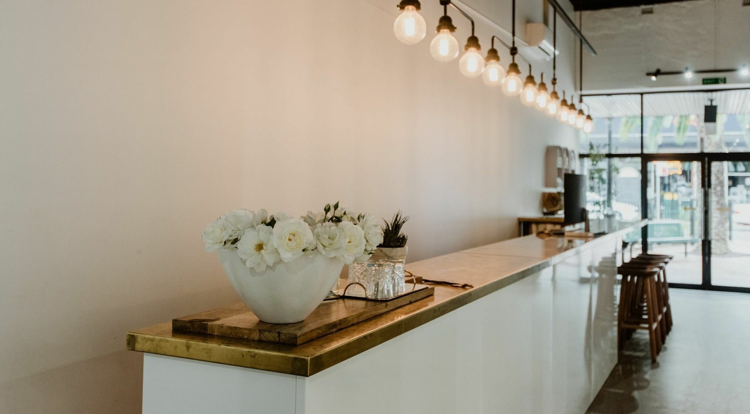 Elegant reception area at Tribecca & Co., Tamworth, New South Wales, AU with flowers and soft lighting.