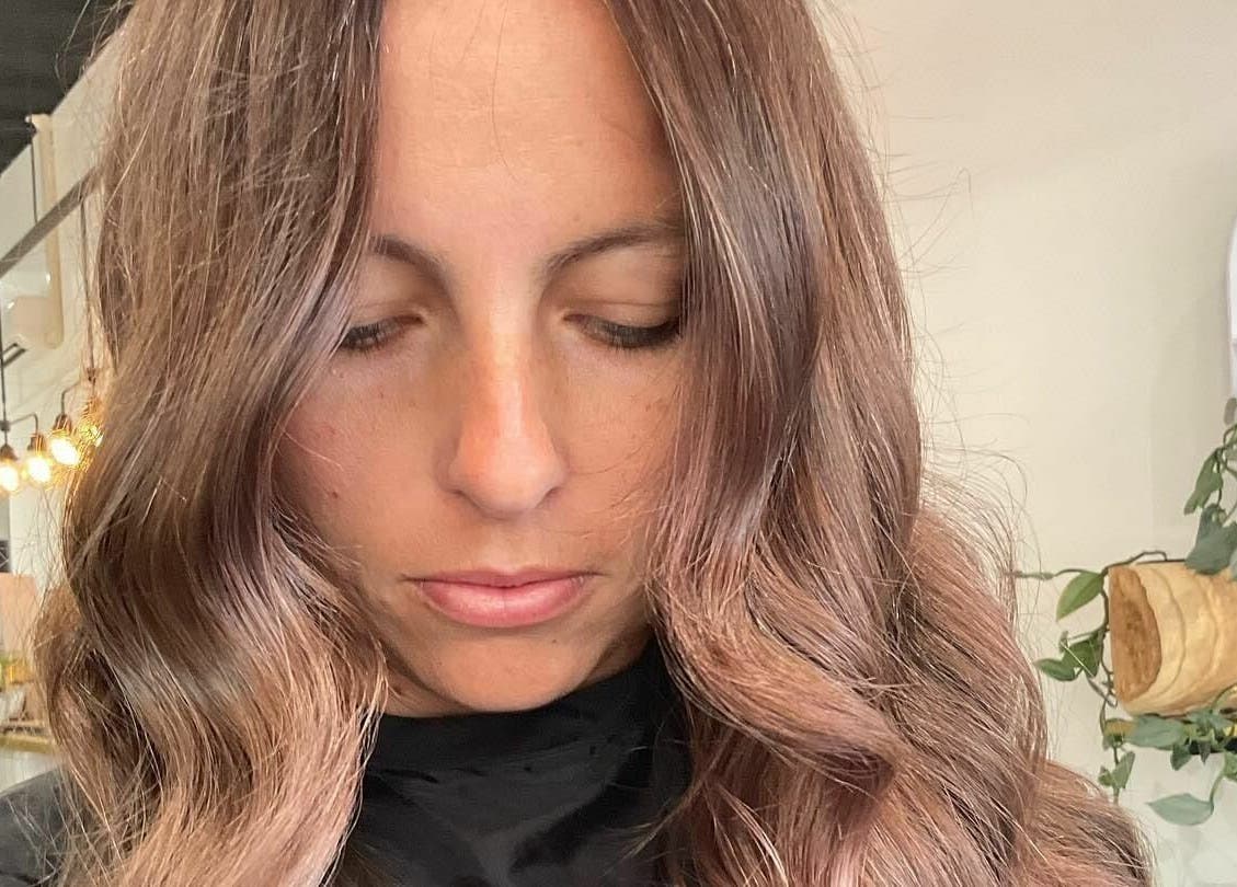 Woman with styled wavy hair at Tribecca & Co., Tamworth, New South Wales, AU. Modern salon interior.