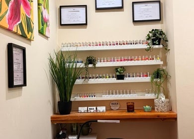 Nail polish collection at Rose Gold Hair & Beauty, Sheffield, England, GB, with vibrant decor and plants.