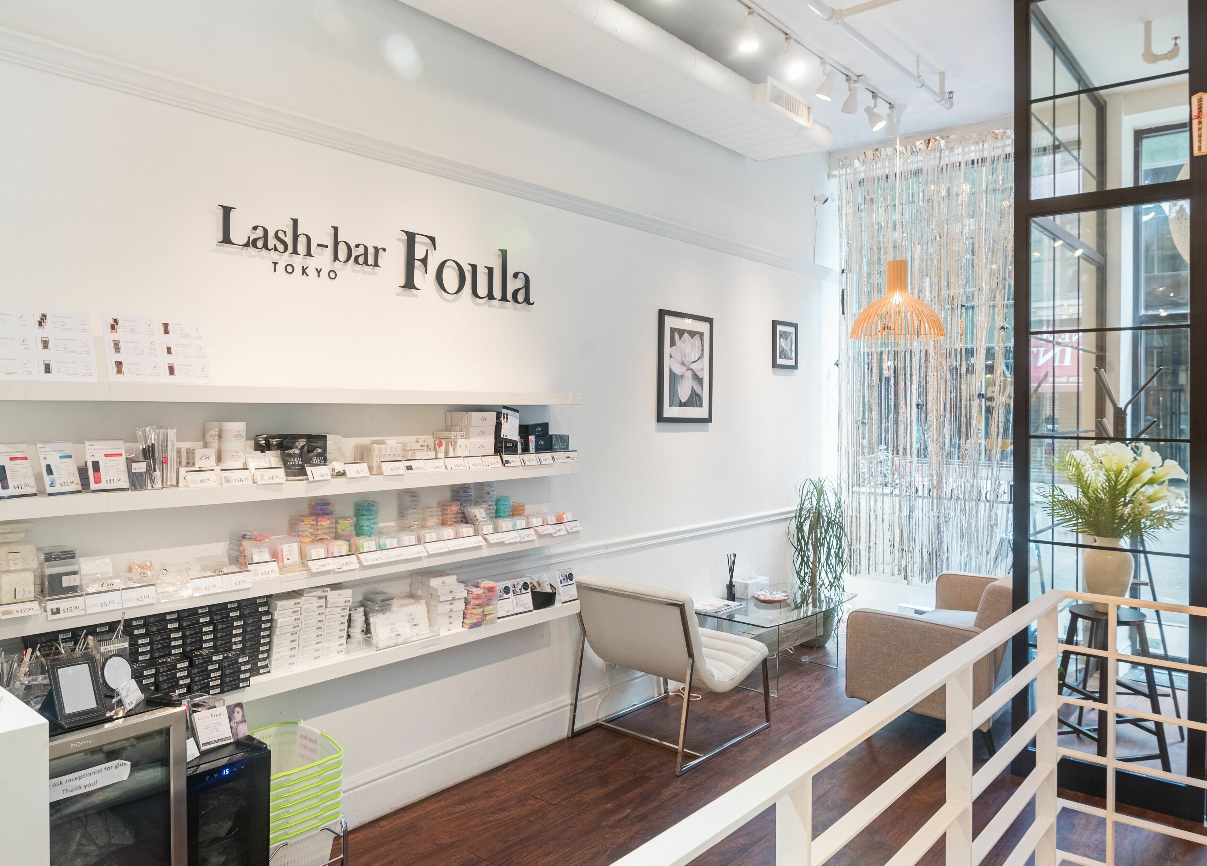 Interior of Lash-bar Foula, New York, featuring sleek shelves and modern decor.