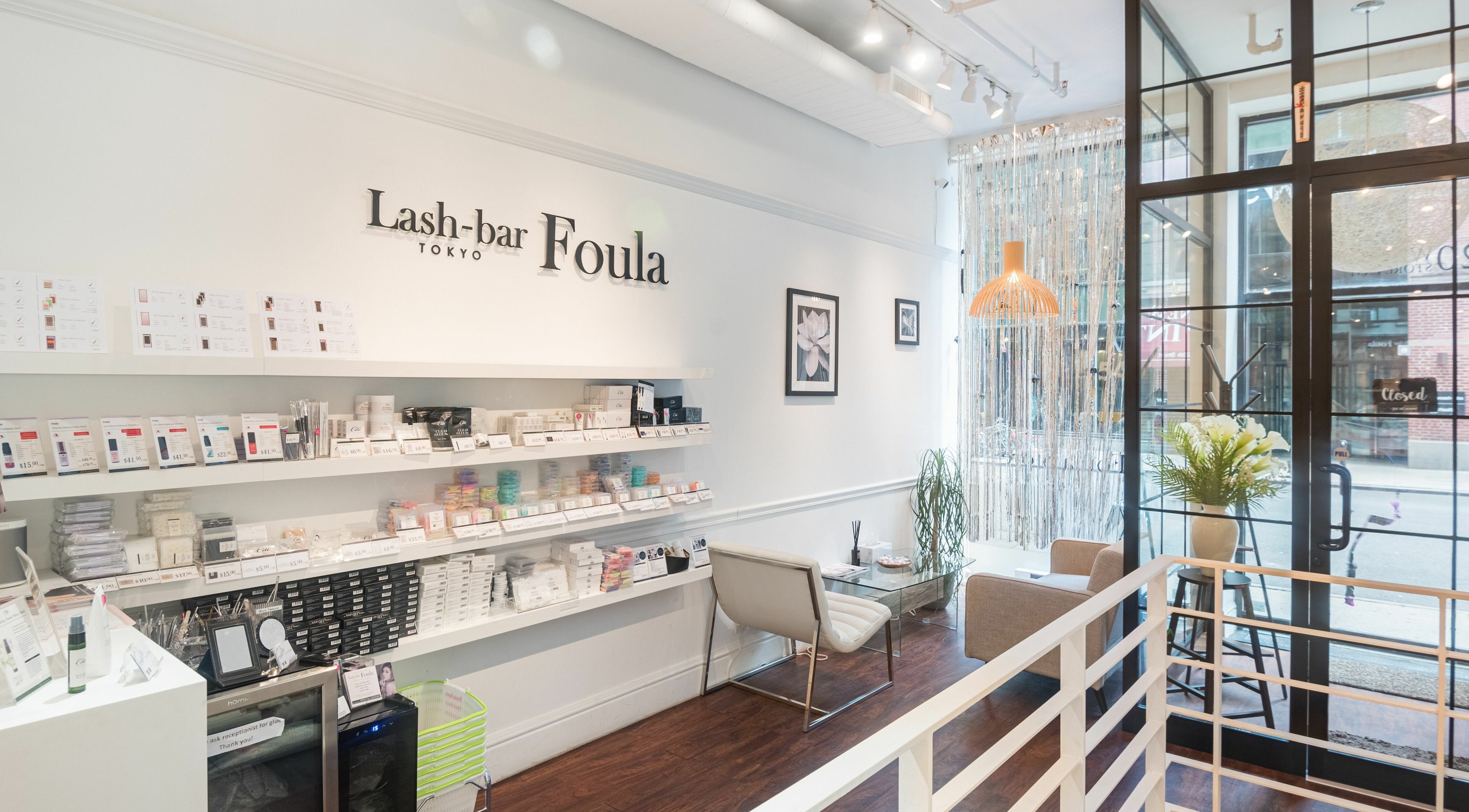 Interior of Lash-bar Foula, New York, featuring sleek shelves and modern decor.