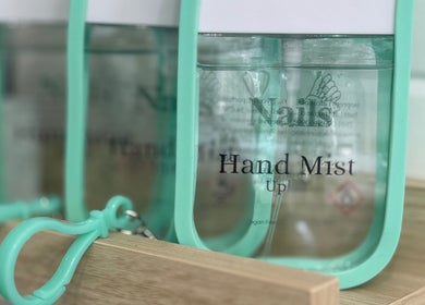 Elegant hand mist display at Nails by Lauren, Halstead, England, GB, showcasing modern beauty essentials.