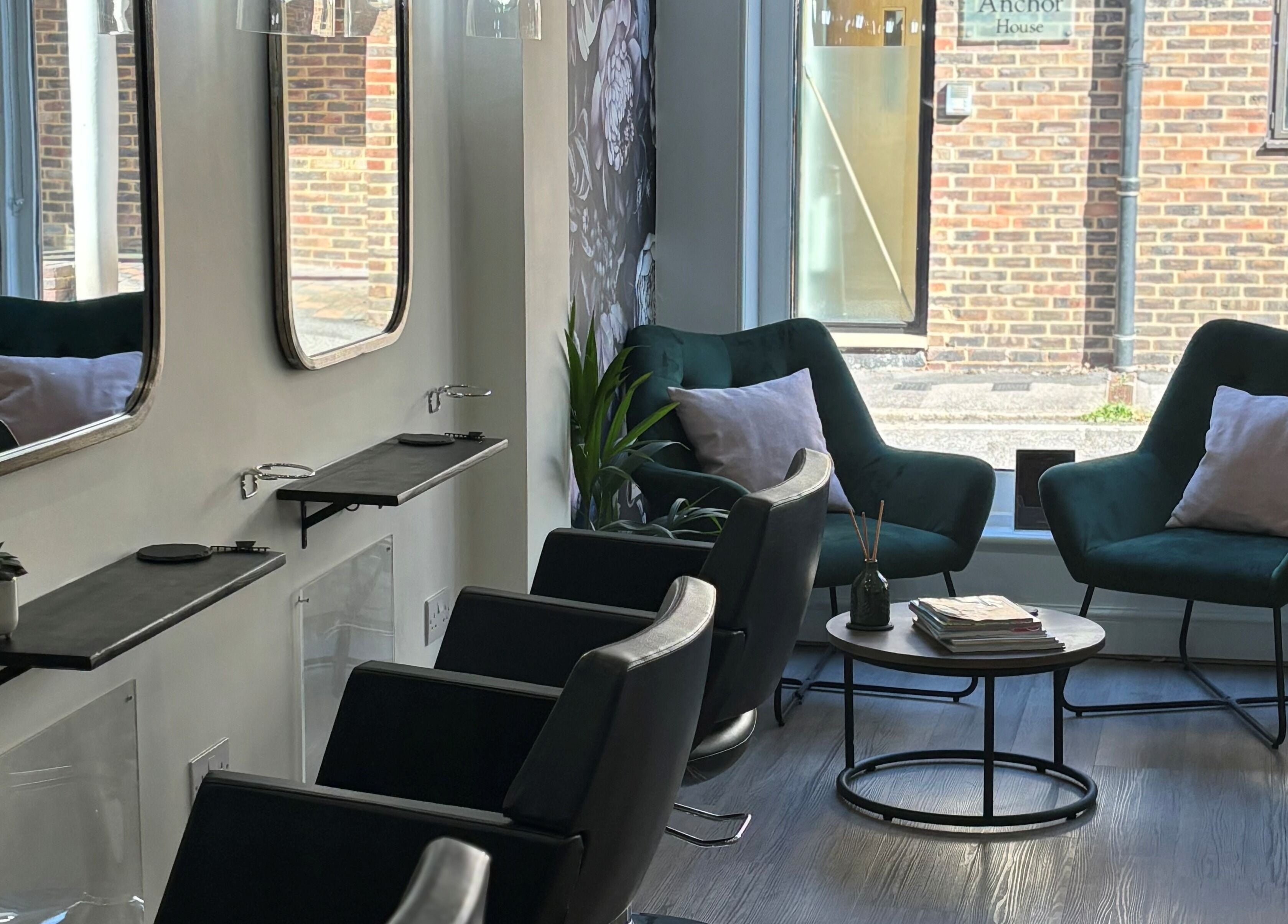 Cozy waiting area at Belle Amour, Bagshot, England, GB with plush chairs and modern decor.