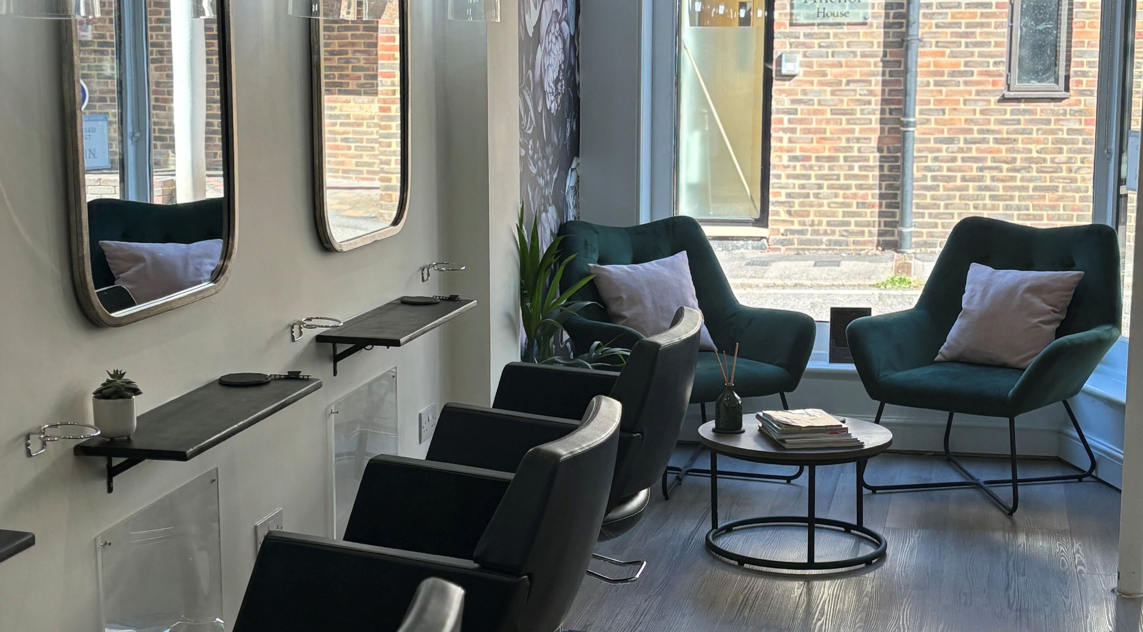 Cozy waiting area at Belle Amour, Bagshot, England, GB with plush chairs and modern decor.