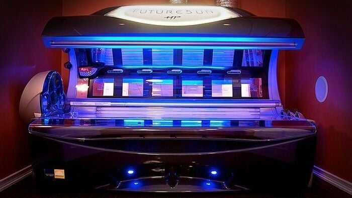 Sleek blue tanning bed at AfterGlow Tanning: Tiverton in Tiverton, Rhode Island, US.