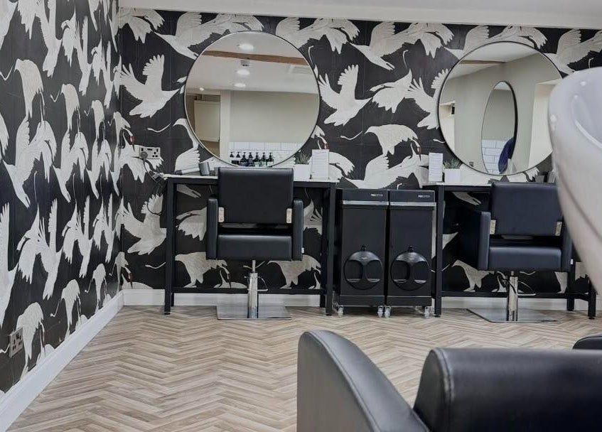 Modern salon chairs at Lilys in Diss, England, GB, featuring elegant decor with crane motifs.
