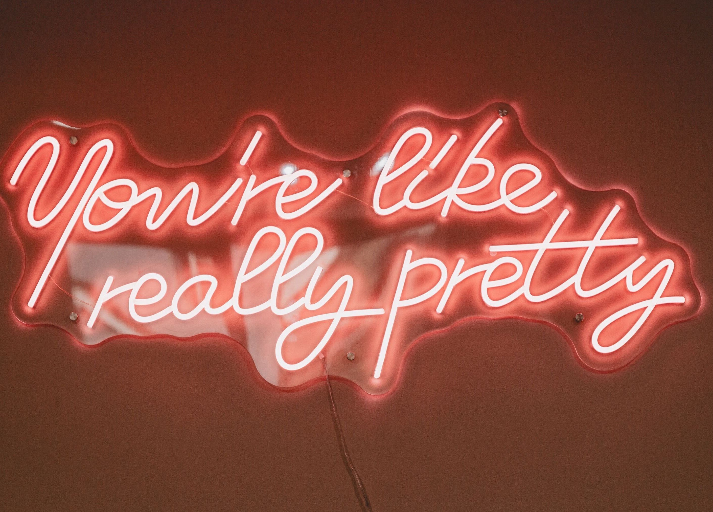 Bright neon sign at Lilys in Diss, England, GB, reading 'You're like really pretty'.