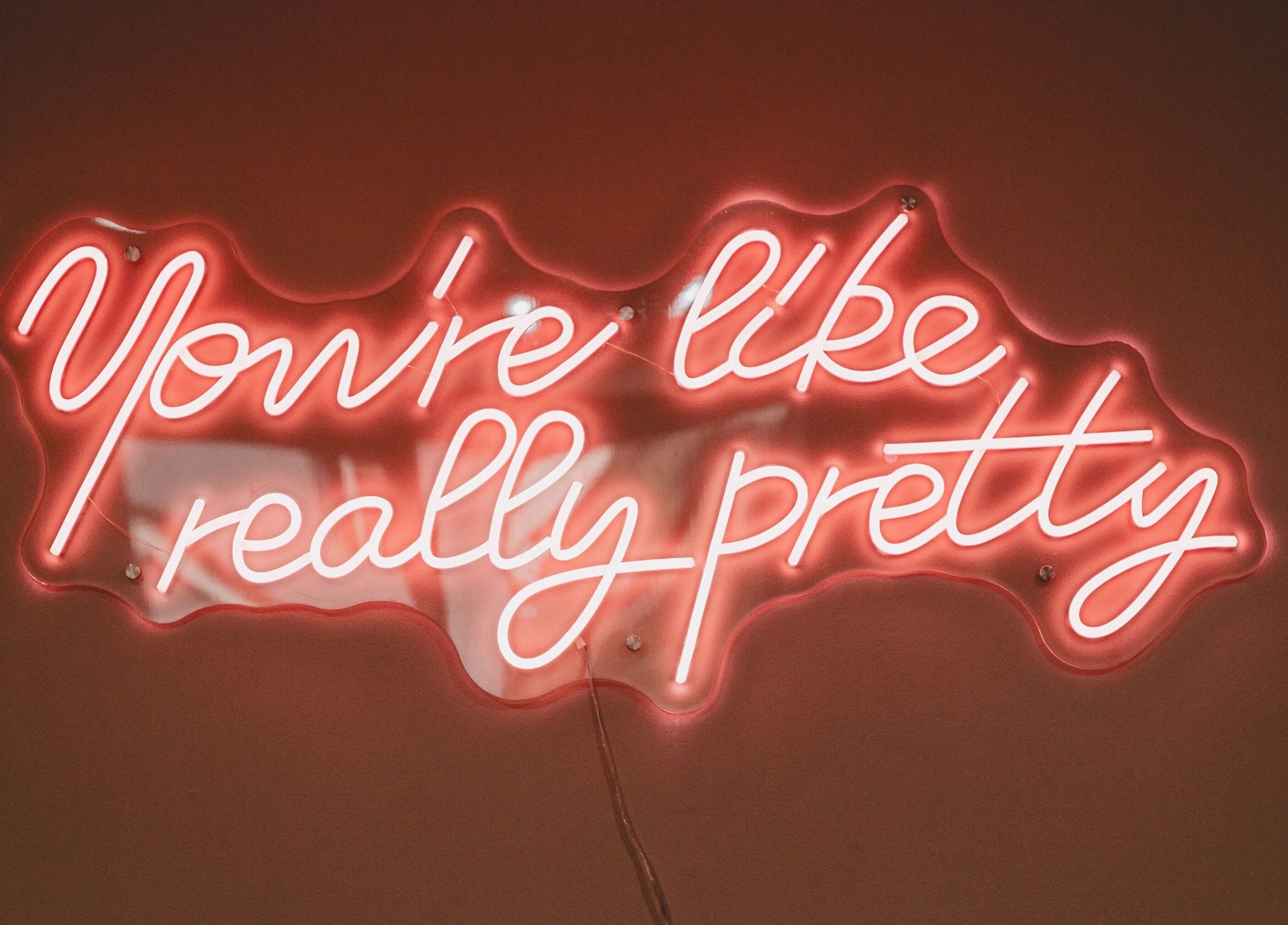 Bright neon sign at Lilys in Diss, England, GB, reading 'You're like really pretty'.