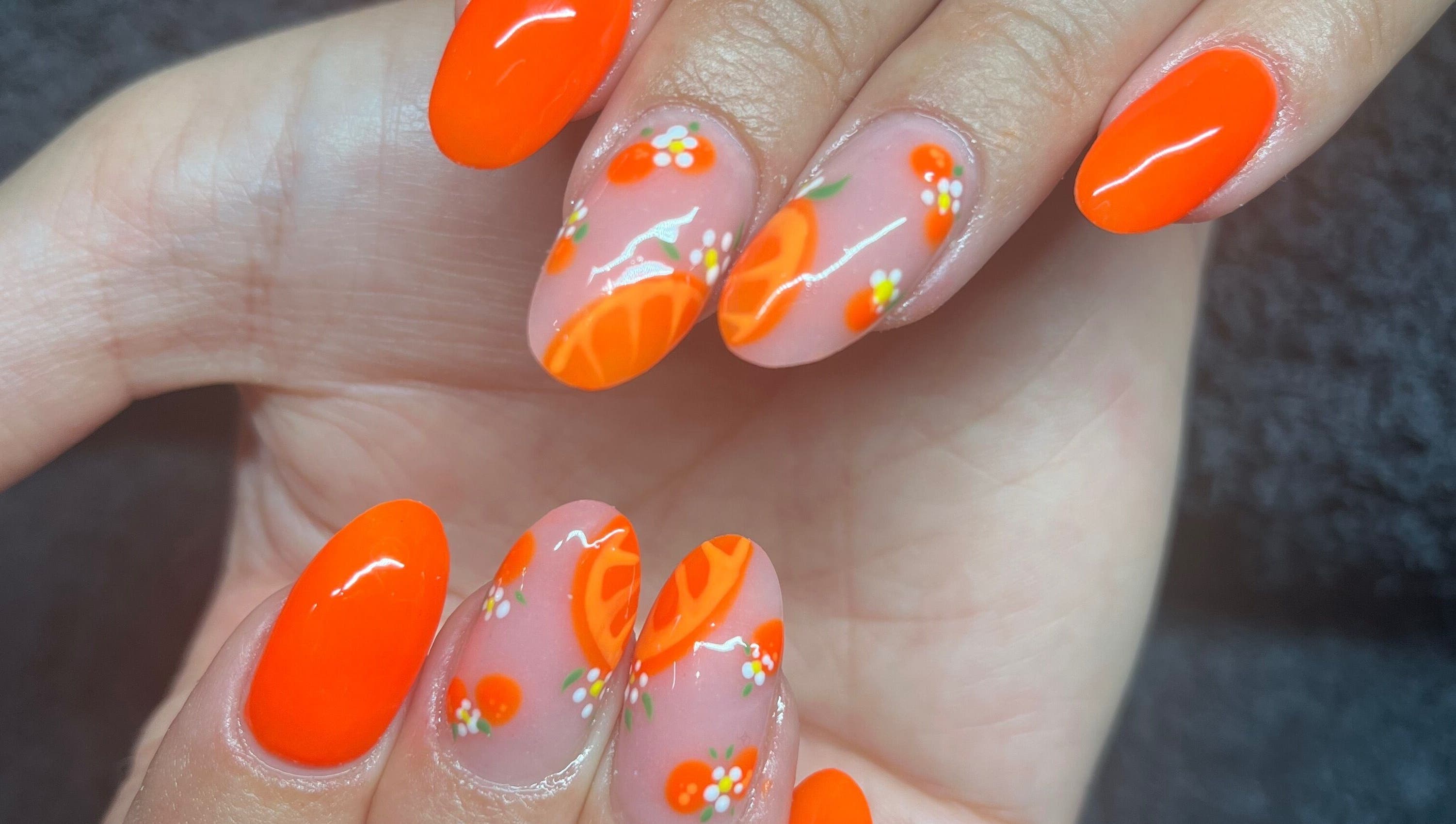 Vibrant citrus nail art at Needham Gym, Ipswich, England, GB showcases intricate design and creativity.